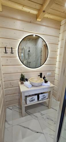 a bathroom with a sink and a mirror at Bieszczadzkie Chaty in Polańczyk