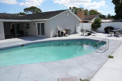 a swimming pool in front of a house at Hosting 1 in Tampa