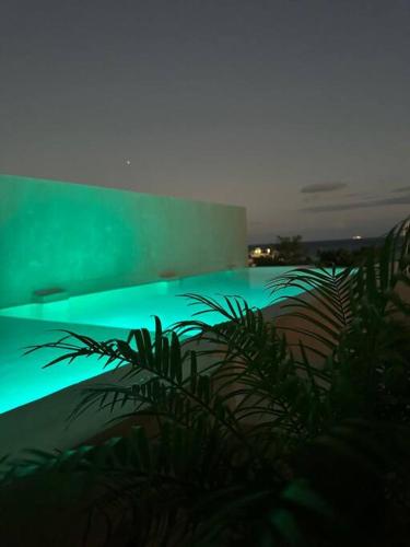 a view of a swimming pool with green illumination at Breathtaking PH 5thAV ocean view private pool roof in Playa del Carmen
