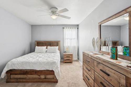 a bedroom with a bed and a mirror and a dresser at Philadelphia Vacation Rental Near Public Transit! in Philadelphia