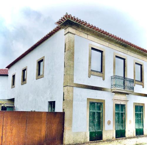 a white house with a fence in front of it at Villa Cornelia, Ponte de Lima in Ponte de Lima
