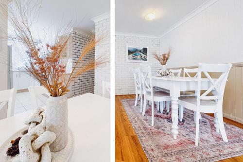 a white dining room with a white table and chairs at Seaside Haven, 3-62 Tomaree Rd - Wi-Fi and perfect for families in Shoal Bay
