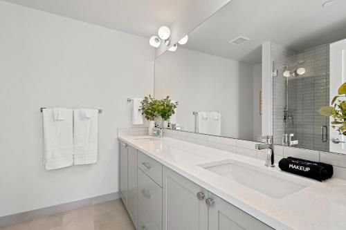 a white bathroom with a sink and a mirror at New Meridian Park Shoreline WA in Shoreline