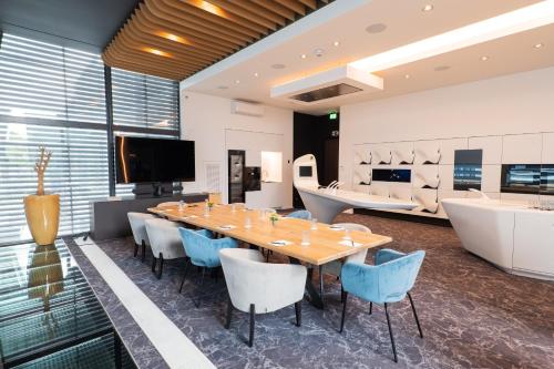 a dining room with a long table and blue chairs at voco Brussels City North by IHG in Vilvoorde