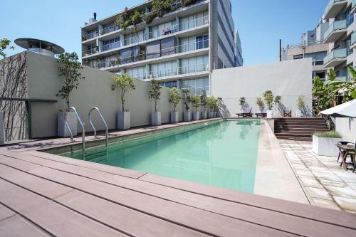 a swimming pool in front of a building at Dazzler by Wyndham Buenos Aires Palermo in Buenos Aires