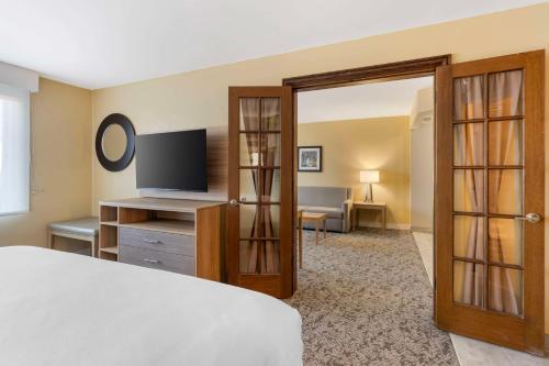 a hotel room with a bed and a television at Best Western Glenview - Chicagoland Inn and Suites in Glenview