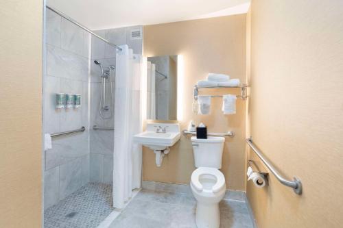 a bathroom with a toilet and a sink and a shower at Best Western Glenview - Chicagoland Inn and Suites in Glenview