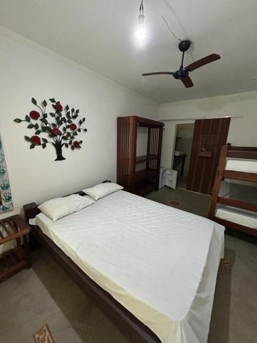 a bedroom with a bed with a flower sticker on the wall at pousada coruja maresias in São Sebastião