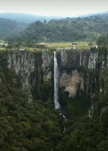 a waterfall on the side of a mountain at Pousada Nó de Pinho in Urubici