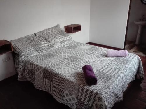 una cama con un calcetín púrpura sentado encima en Casa del Bosque en Mar del Plata