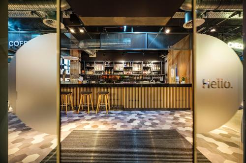 a restaurant with a bar with tables and chairs at Holiday Inn Express Dresden Zentrum, an IHG Hotel in Dresden