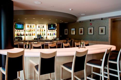 a bar in a restaurant with chairs and tables at Beechwood Hotel in Worcester