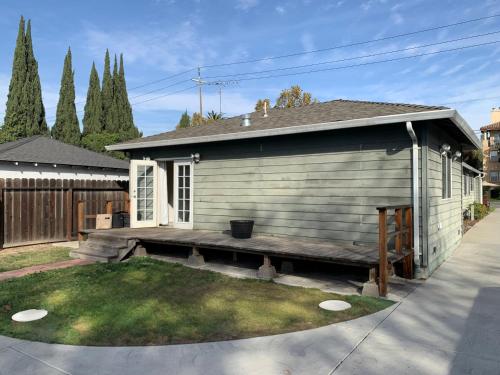 a small house with a bench in the yard at West Wing in San Jose