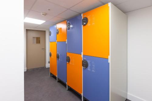 a row of colorful lockers in an office building at Staybridge Suites - Cannes Centre by IHG in Cannes