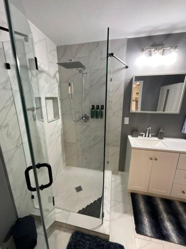 a bathroom with a shower and a sink at Luxury home in the nature in Gleneagle