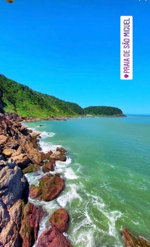 a view of the ocean from a rocky beach at Chalés do Parque Hospedagem in Penha