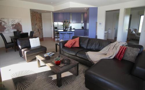 a living room with a couch and a table at Hilltop Apartments Phillip Island in Cowes