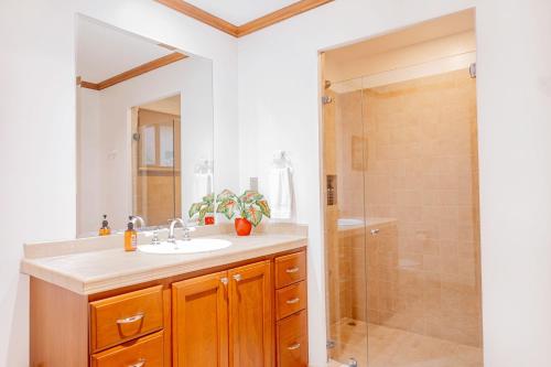a bathroom with a sink and a shower at Secluded Garden Paradise Condo @Los Sueños in Herradura