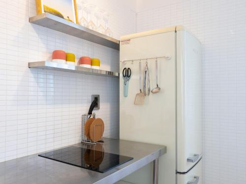 a kitchen with a counter and a refrigerator at Boutique Pool Villa NAMIB in Jeju