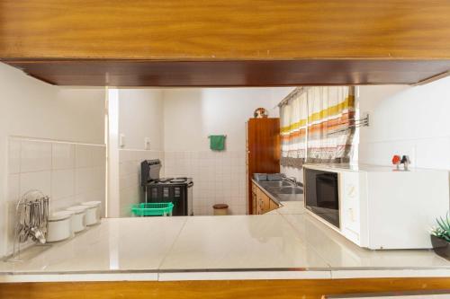 a kitchen with a white counter and a microwave at Amanzi402 Oceanview Retreat in Amanzimtoti