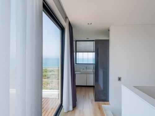 a bathroom with a view of the ocean from a window at Boutique Pool Villa NAMIB in Jeju