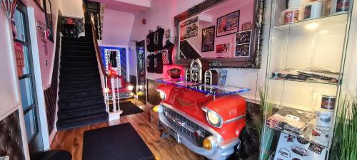 a room with a room with a toy fire truck at Cadillac Kustomz Hotel in Rothesay