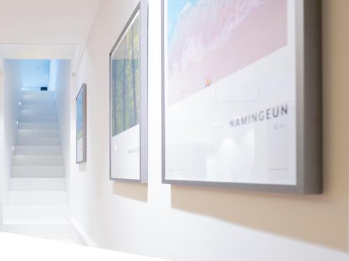 a row of posters on a wall in a museum at Boutique Pool Villa NAMIB in Jeju