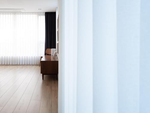 an open door to a room with a desk at Boutique Pool Villa NAMIB in Jeju