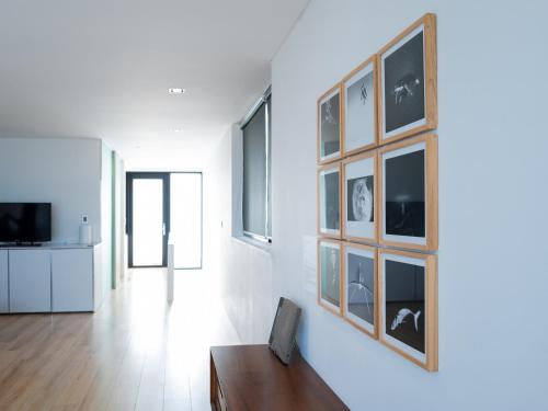 a living room with a couch and a tv at Boutique Pool Villa NAMIB in Jeju