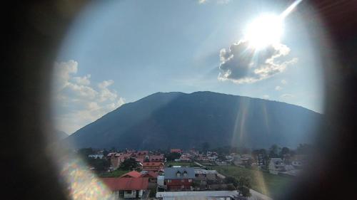 a view of a city with a mountain in the background at Hospedaje Oxa Paraíso in Oxapampa