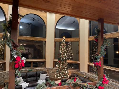 a living room with a christmas tree in the center at Crestview Estate 5 acres-heated pool-5min to strip in Pigeon Forge