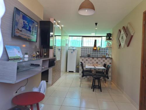 a kitchen with a table and chairs in a kitchen at Maragogi Flat Residence in Maragogi
