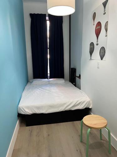 a small bedroom with a bed and a table at East Harlem Hostel in New York