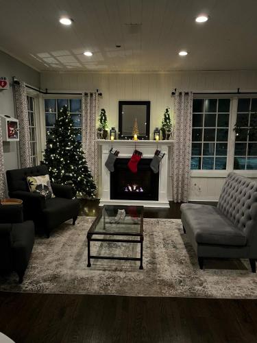 a living room with a christmas tree and a fireplace at The Inn at Longshore in Westport