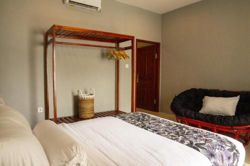 a bedroom with a large bed and a mirror at Uluwatu Stay's Standard Room #1 in Uluwatu