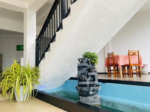 a swimming pool in a living room with a house at Cinnamon City in Hikkaduwa