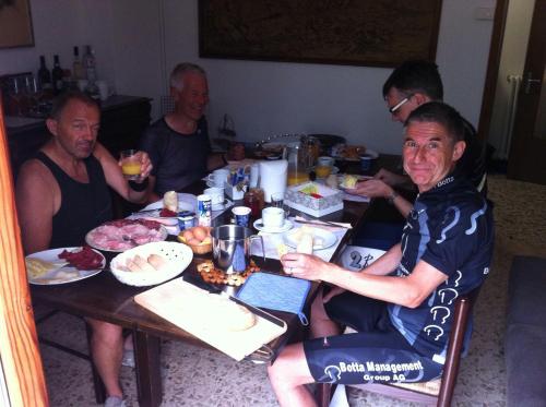 a group of men sitting around a table eating food at Bed & Breakfast Casa Marinella in Lenna