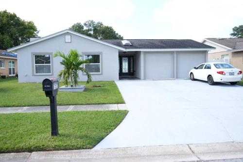 a white car parked in front of a house at Hosting 1 in Tampa