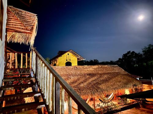 a view of a building with a roof and a church at Vila Ypáwa 150 m centro 30 m praia lago verde in Alter do Chao