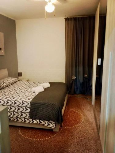 a bedroom with a bed with a black and white blanket at HOME ADRIANA in Bari
