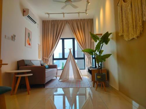 a living room with a couch and a large window at The Horizon by MyKey in Ipoh