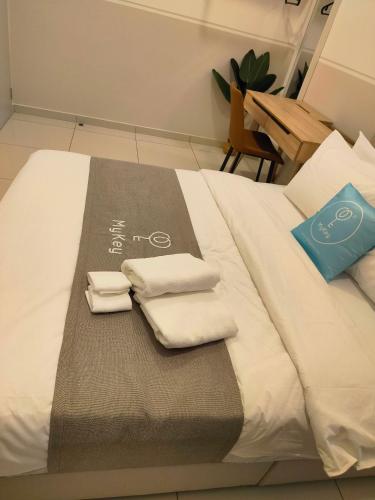 a bed with two towels and two pillows on it at The Horizon by MyKey in Ipoh