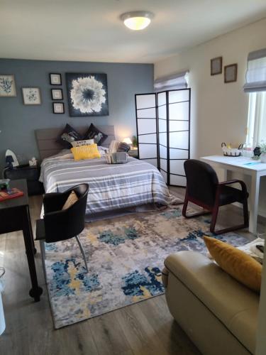 a bedroom with a bed and a living room at Levander Cozy Home in Alhambra