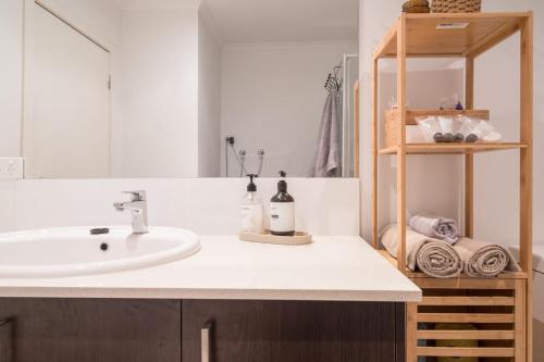 a bathroom with a sink and a mirror at Capel Sound Family Comforts on the Foreshore in Rosebud