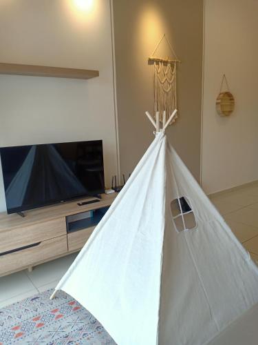 a white teepee tent in front of a tv at The Horizon by MyKey in Ipoh