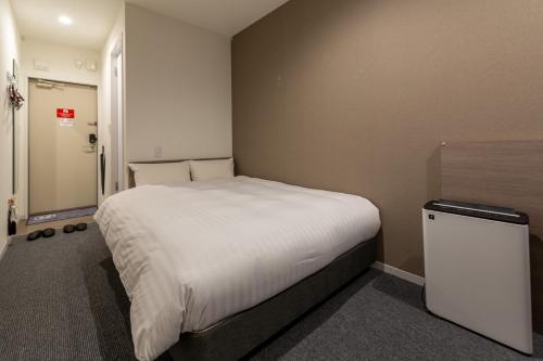 Postel nebo postele na pokoji v ubytování HOTEL R9 The Yard Nagahama
