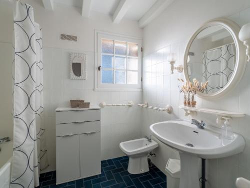une salle de bain blanche avec un lavabo et des toilettes dans l'établissement Grande maison landaise avec piscine privée, proche plage, pour 8 personnes à Biscarrosse - FR-1-319-398, à Biscarrosse-Plage