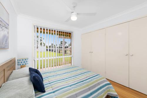a bedroom with a bed and a window at 3 Redman Place in Soldiers Point