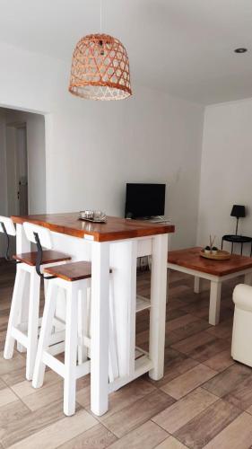 a white dining room table with a laptop on it at SoHo Flat in Tandil