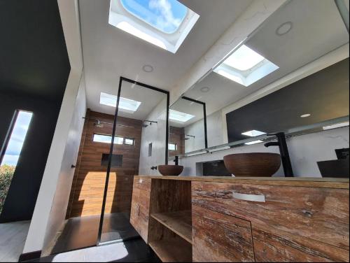 a bathroom with a large mirror and a sink at Carmesí Smart Glamping in Simijaca